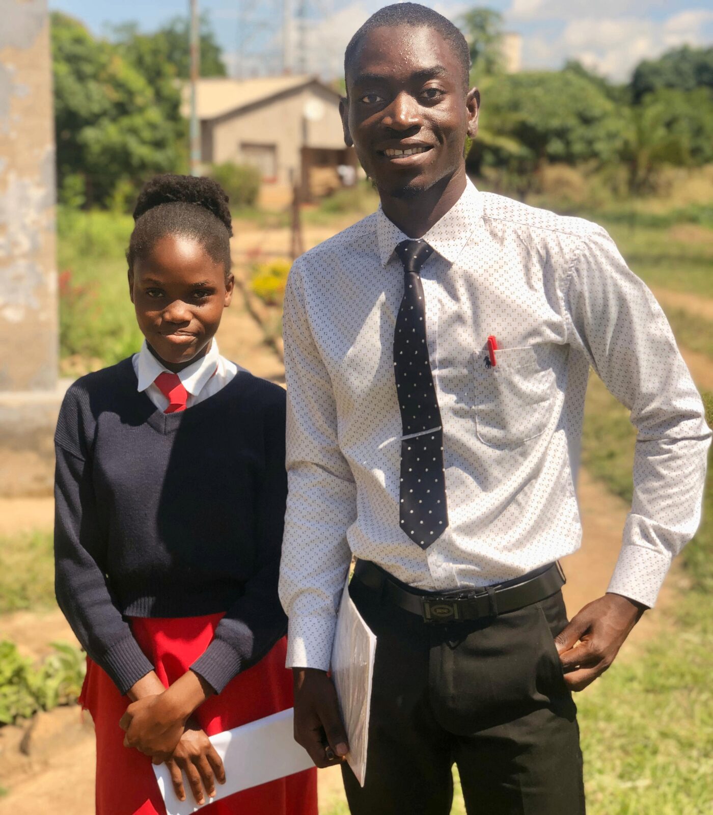Ronald mentoring a young student in school uniform