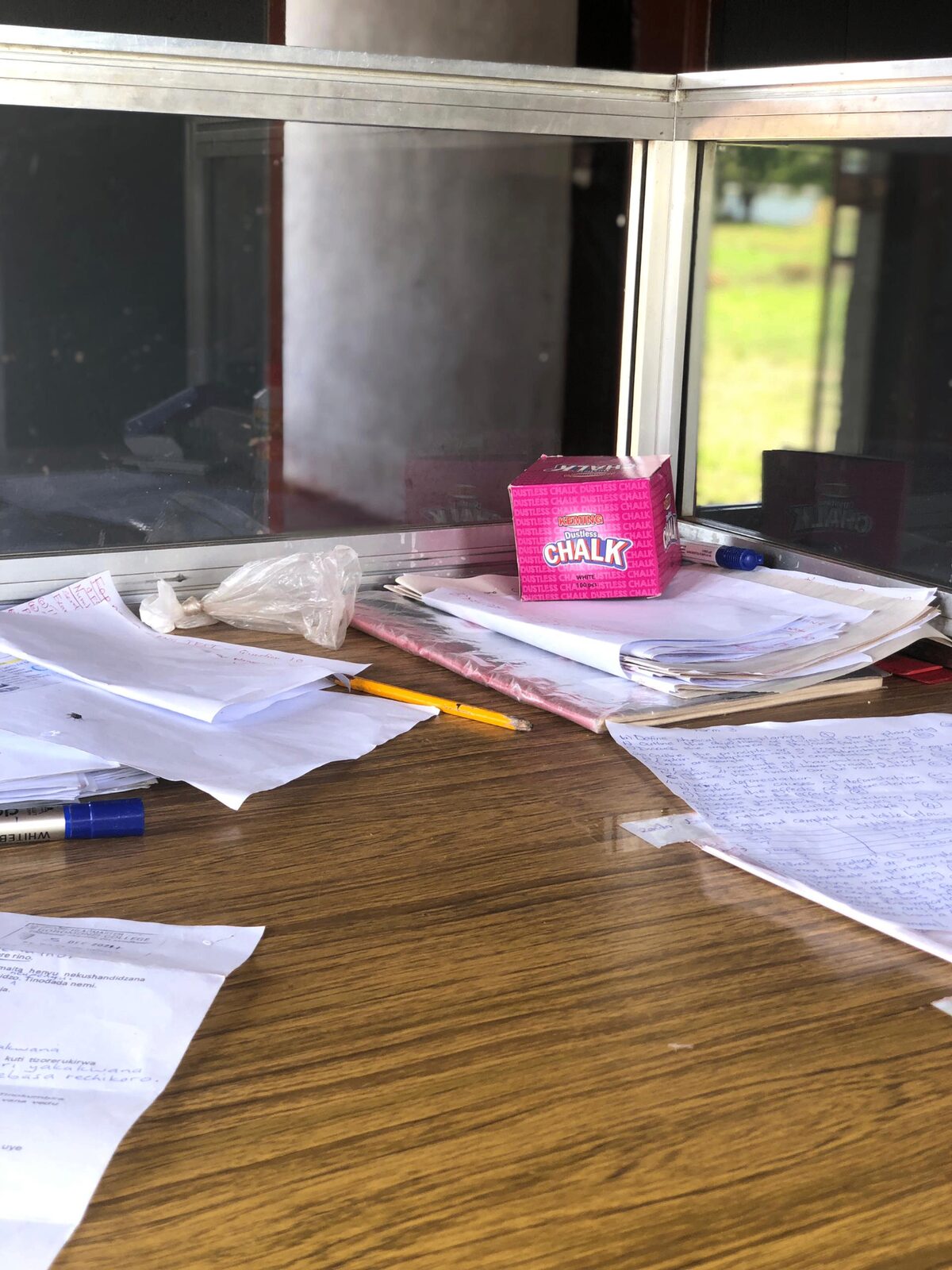 A teacher's desk with notes and chalk — daily classroom life